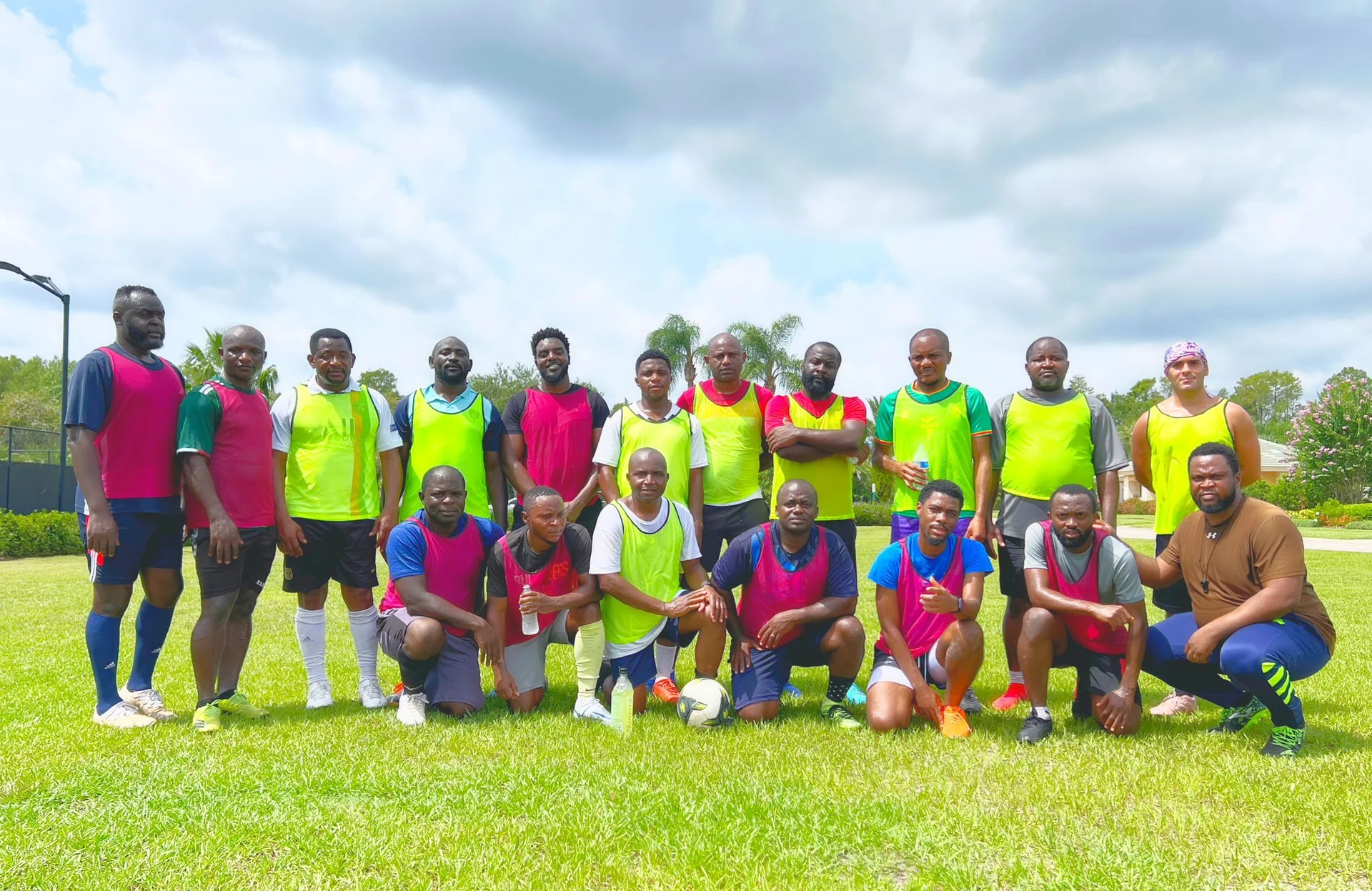 Practice group posing together in brightly colored training bibs