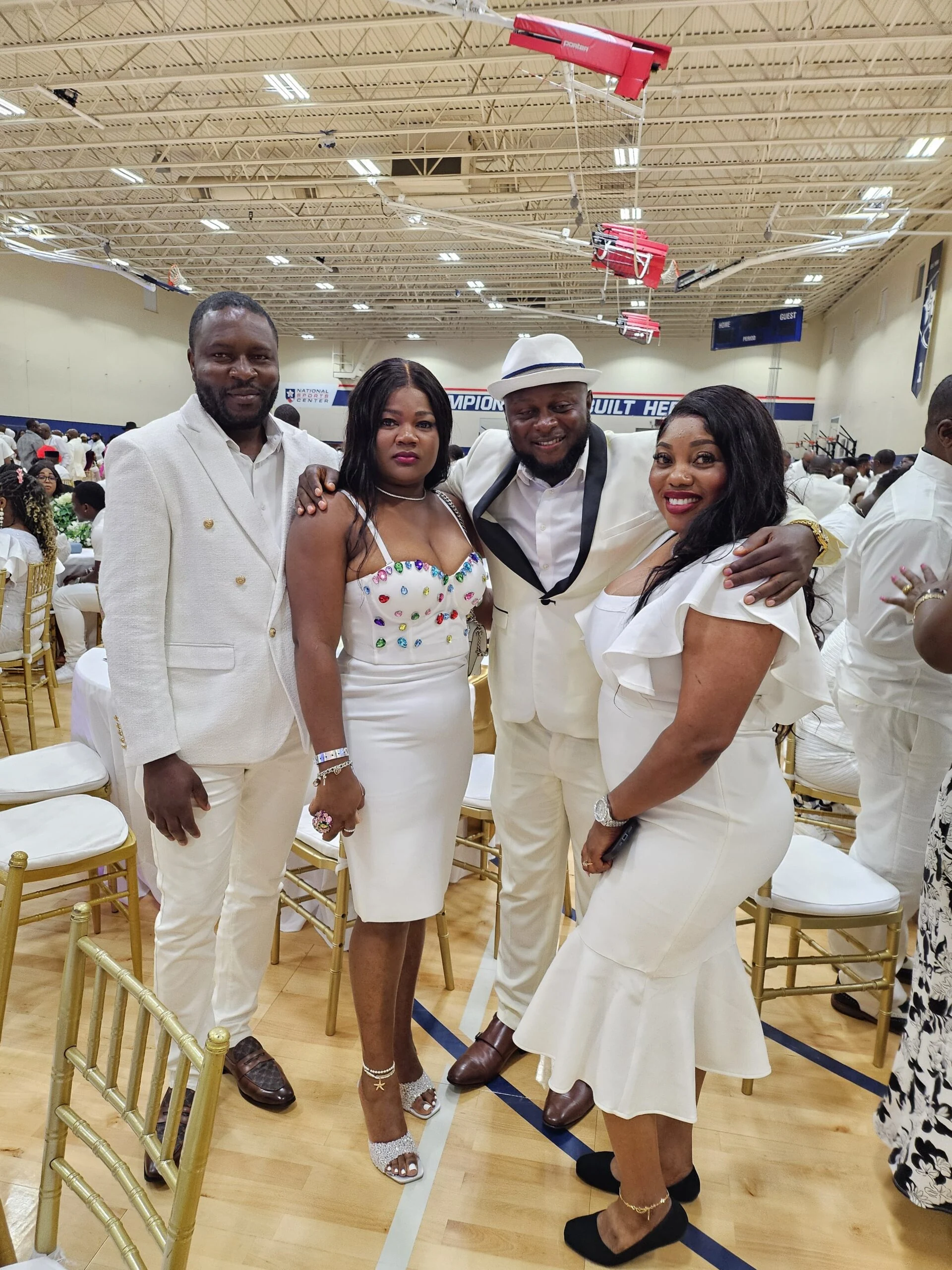 Four guests dressed in white at a banquet
