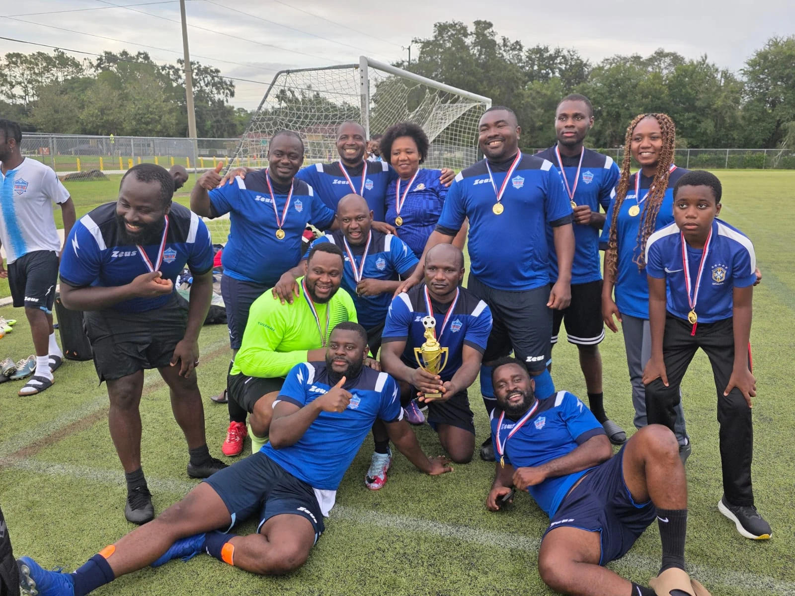 Tampa Veterans players celebrating with medals and a trophy